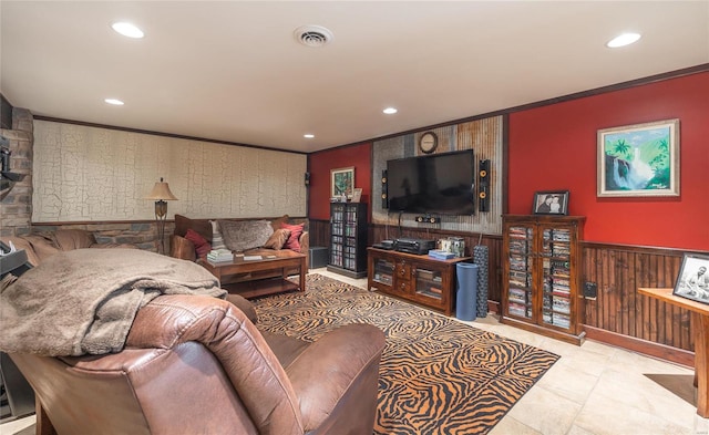 living room with ornamental molding and light tile patterned floors