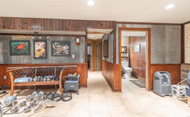 miscellaneous room with crown molding and wood walls