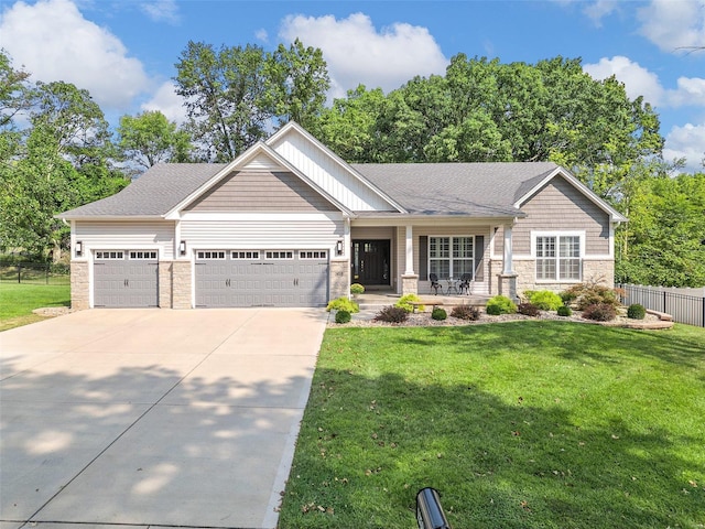 craftsman house with a front yard, a garage, and a porch