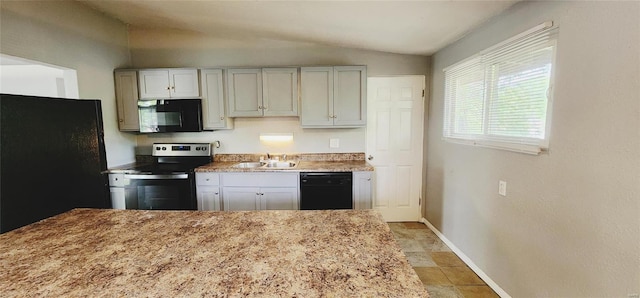 kitchen with black appliances, sink, and vaulted ceiling