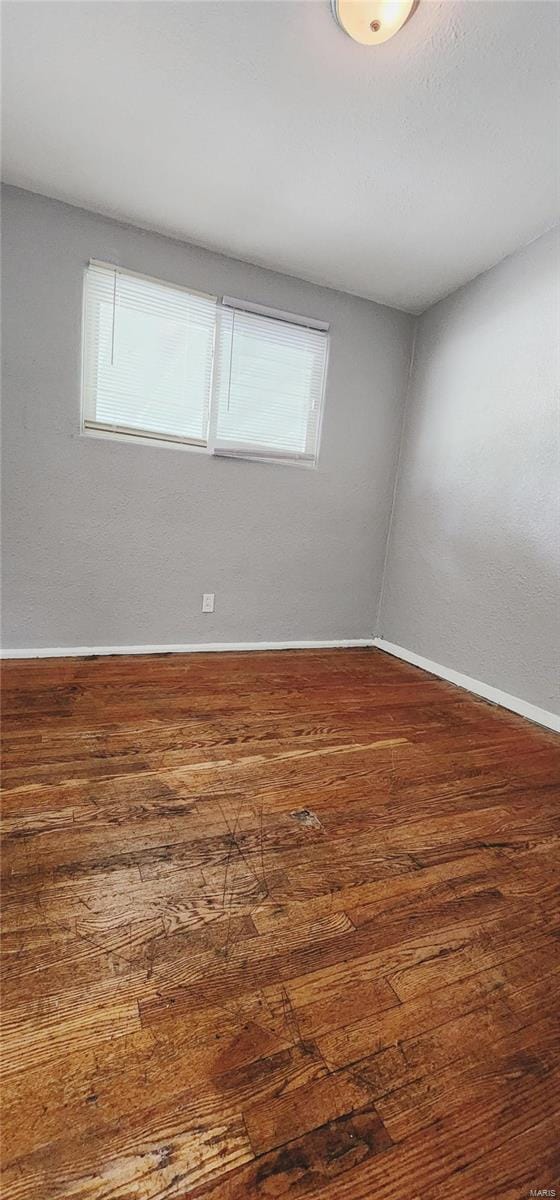 empty room with wood-type flooring