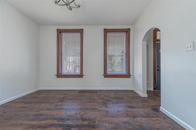 unfurnished room featuring dark hardwood / wood-style floors and plenty of natural light