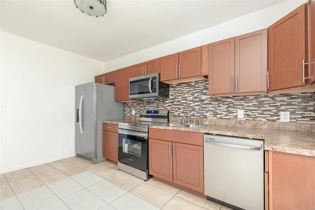 kitchen with decorative backsplash, sink, light tile patterned floors, and stainless steel appliances