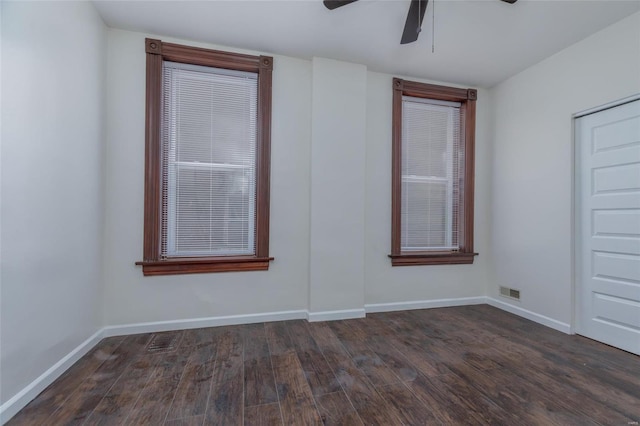 spare room with dark wood-type flooring and ceiling fan