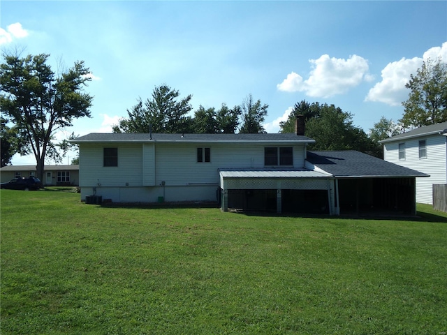 rear view of house featuring a lawn