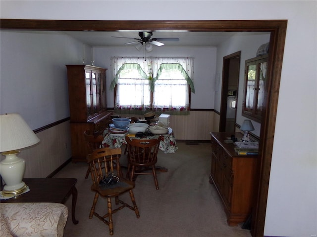 dining space with ceiling fan and carpet floors