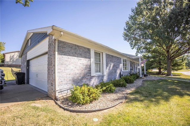 view of side of home with a lawn and a garage