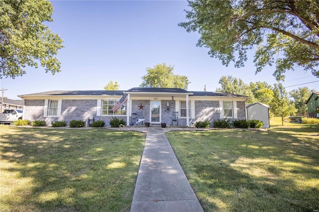 ranch-style home with a storage shed and a front lawn