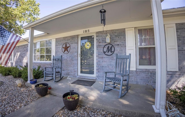 view of exterior entry featuring a porch