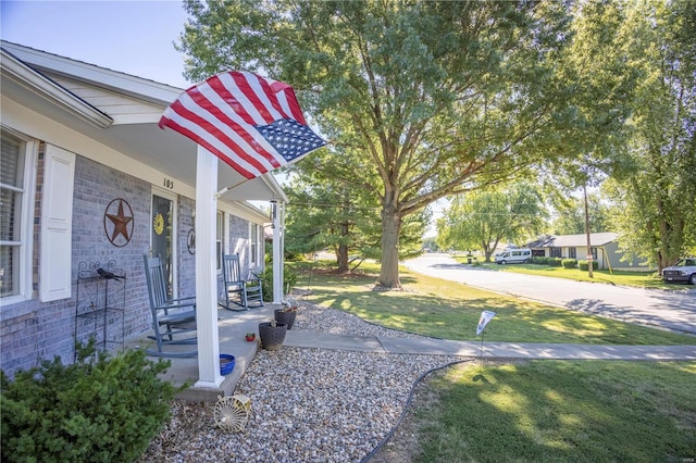 view of yard featuring covered porch