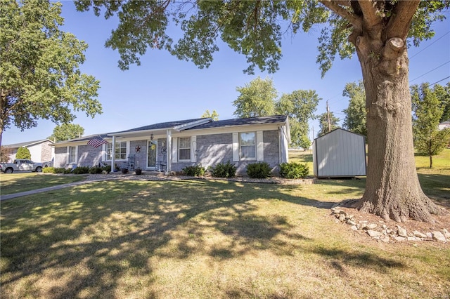 ranch-style house featuring a storage shed and a front yard