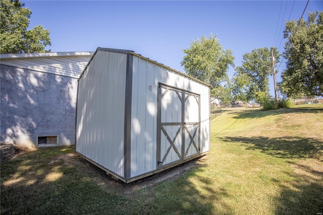 view of outbuilding with a yard