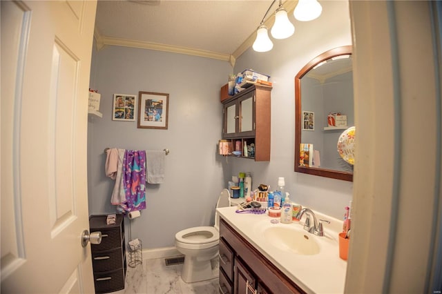 bathroom featuring a textured ceiling, vanity, toilet, and ornamental molding