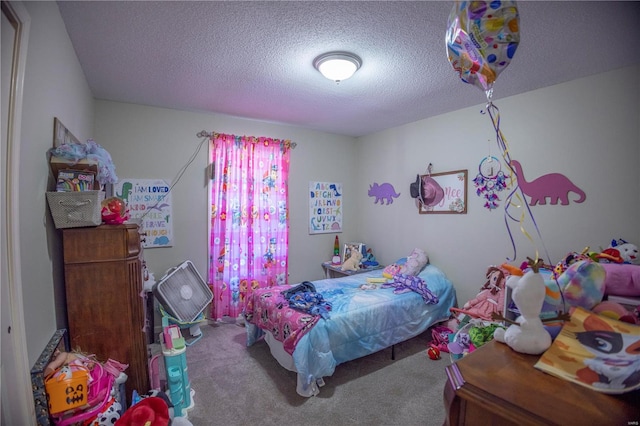 bedroom featuring a textured ceiling and carpet floors