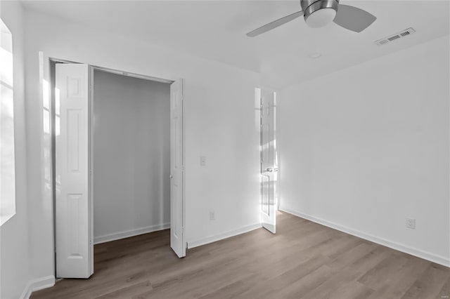 unfurnished bedroom with a closet, ceiling fan, and light wood-type flooring