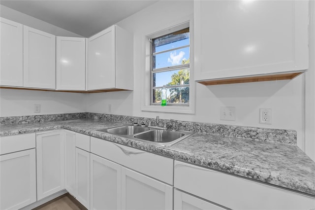 kitchen featuring sink and white cabinets