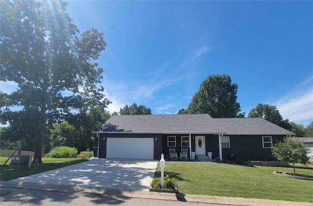 single story home featuring a garage and a front yard