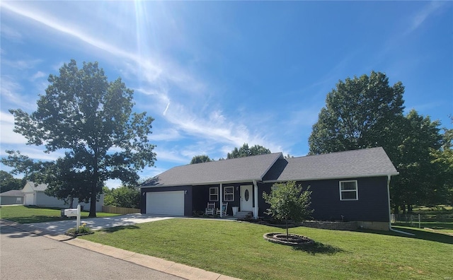 single story home with a garage and a front lawn