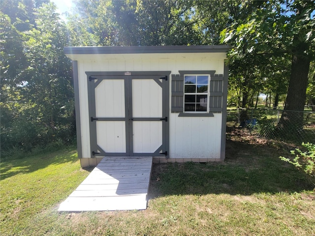 view of outbuilding with a lawn