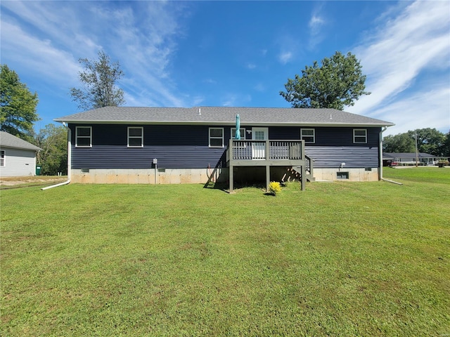 back of property with a lawn and a deck