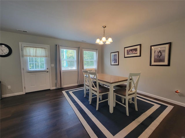 dining space with a notable chandelier and dark hardwood / wood-style floors