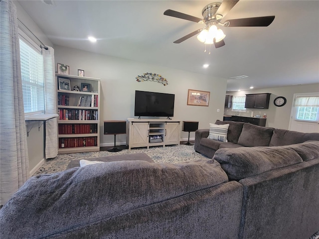 carpeted living room featuring ceiling fan