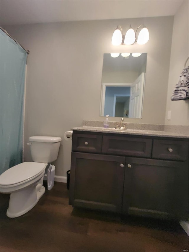 bathroom with vanity, toilet, a shower with curtain, and hardwood / wood-style floors