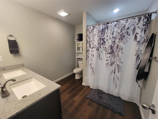 bathroom with a shower with shower curtain, vanity, toilet, and wood-type flooring