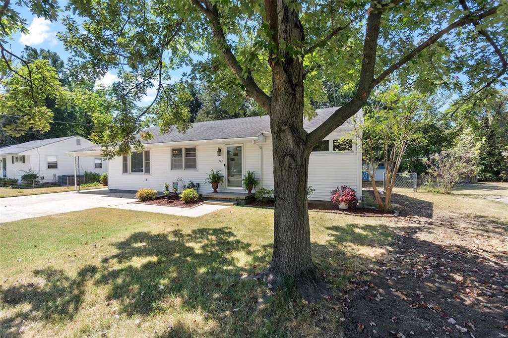 ranch-style home with a front lawn and a carport