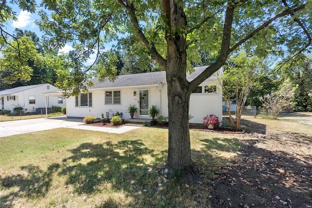 ranch-style home with a front lawn and a carport