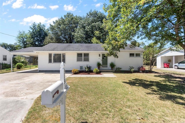 ranch-style house featuring a carport and a front lawn