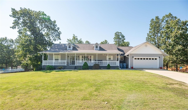 view of front of property featuring a garage, a front yard, and covered porch