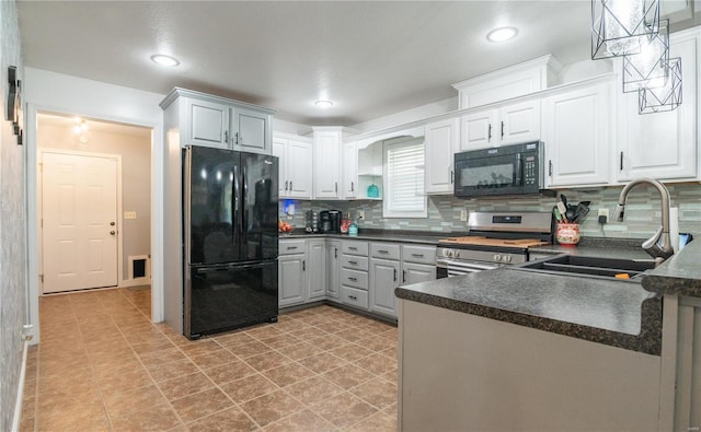 kitchen with pendant lighting, white cabinetry, black appliances, sink, and decorative backsplash