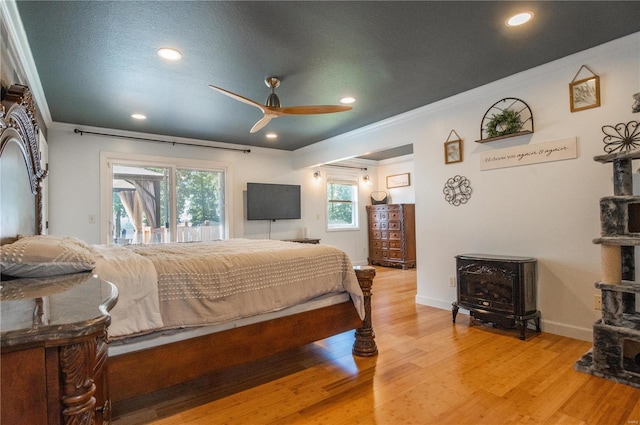 bedroom with a textured ceiling, access to exterior, ornamental molding, hardwood / wood-style flooring, and ceiling fan