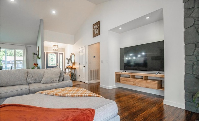 living room with high vaulted ceiling and dark hardwood / wood-style flooring