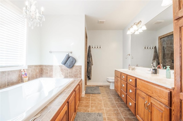 bathroom featuring a bath, tile patterned flooring, toilet, and vanity