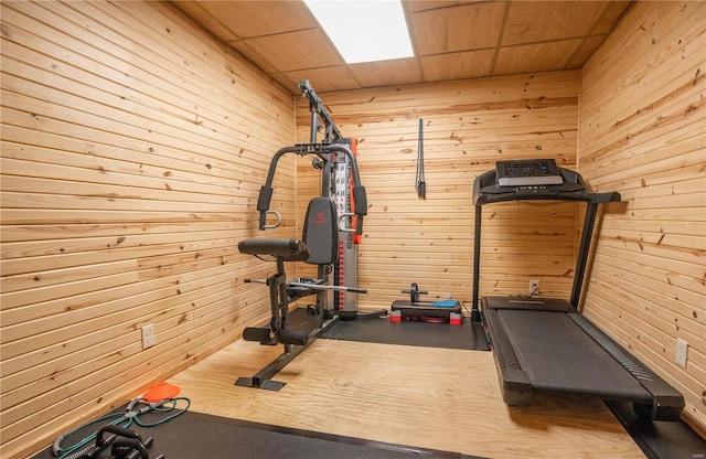 workout room featuring wood walls