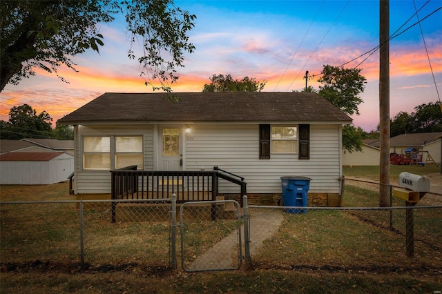 back house at dusk with a yard