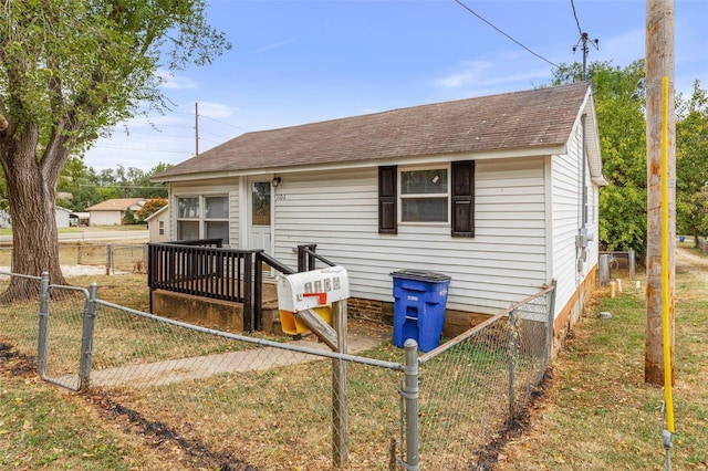 back of property featuring a lawn