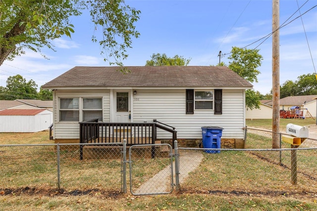 rear view of house with a lawn