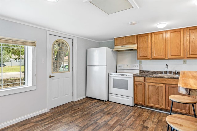 kitchen featuring white appliances, dark hardwood / wood-style floors, and sink