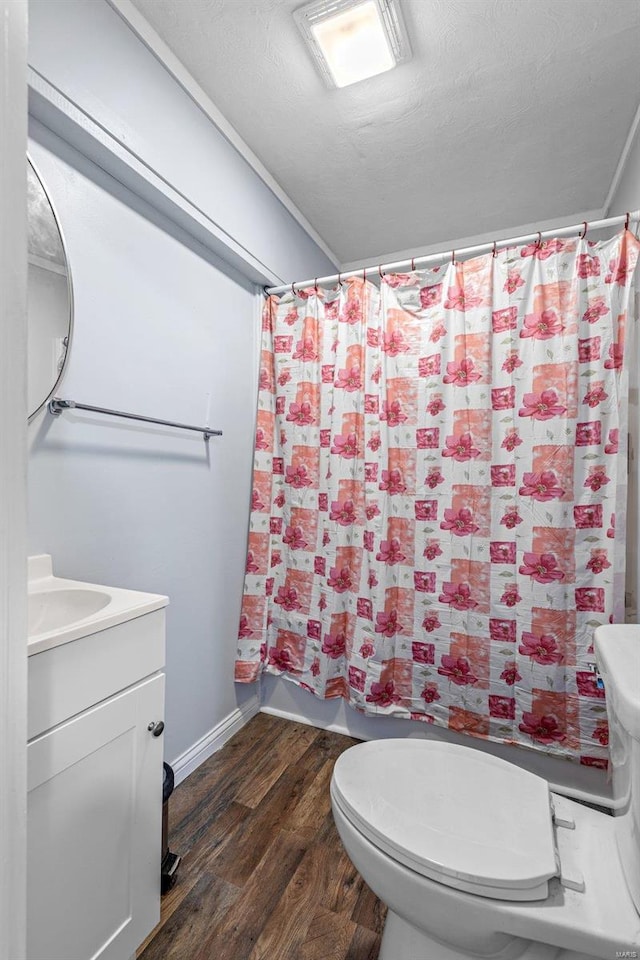 bathroom with vanity, a textured ceiling, hardwood / wood-style flooring, toilet, and a shower with shower curtain