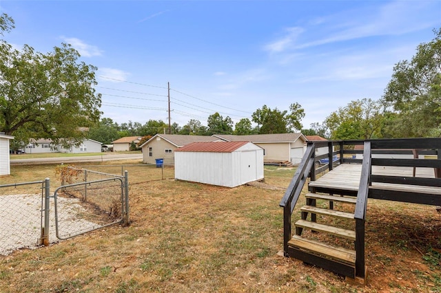 view of yard with a storage unit and a wooden deck