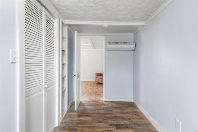 corridor featuring a textured ceiling, dark wood-type flooring, and a wall mounted AC