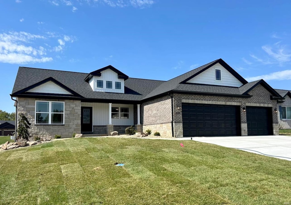 view of front of house featuring a front yard and a garage