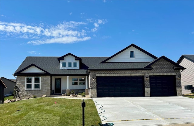 view of front of home with central AC, a garage, and a front lawn