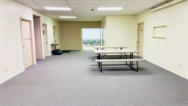 miscellaneous room with carpet flooring and a paneled ceiling