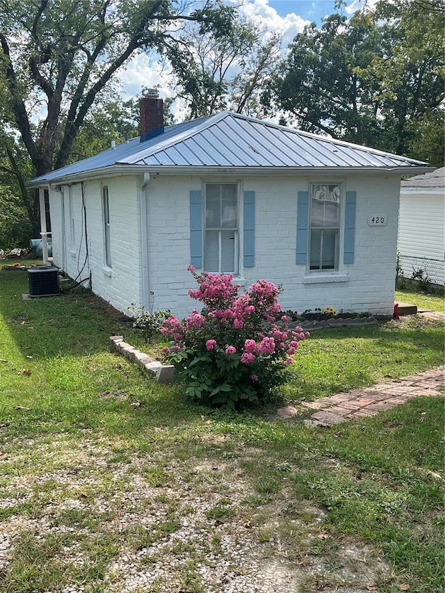 exterior space with a yard and central air condition unit