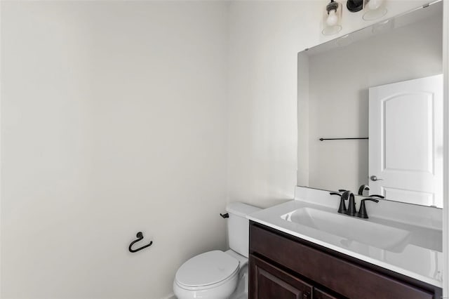 bathroom featuring toilet and vanity