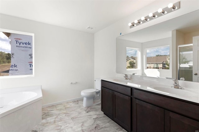 full bathroom with a garden tub, toilet, double vanity, and a sink